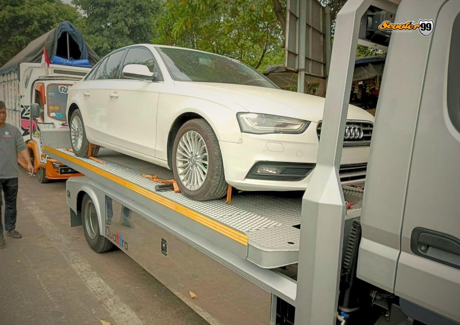 Towing truck in action, securing a vehicle on the roadside